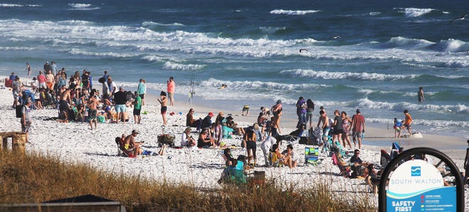 Crowds enjoy the beach and water at Miramar Beach as the last hours of 2020 tick off the clock in South Walton County. A surge in New Year's holiday visitors brought summer-like crowds to the area.