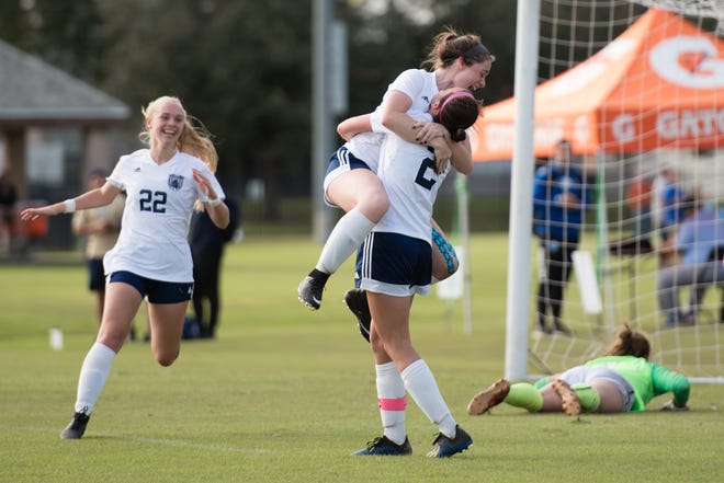 Johnson University women’s soccer team celebrates a goal.