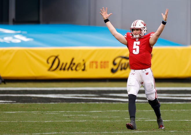 Quarterback Graham Mertz raises his arms after a touchdown in the fourth quarter of the Duke's Mayo Bowl Wednesday in Charlotte.