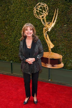 FILE - In this April 29, 2016 file photo, Dawn Wells arrives at the Daytime Creative Arts Emmy Awards at the Westin Bonaventure Hotel  in Los Angeles.  Wells, who played the wholesome Mary Ann among a misfit band of shipwrecked castaways on the 1960s sitcom "Gilligan's Island, died Wednesday, Dec. 30, 2020,  of causes related to COVID-19, her publicist said. (Photo by Chris Pizzello/Invision/AP)