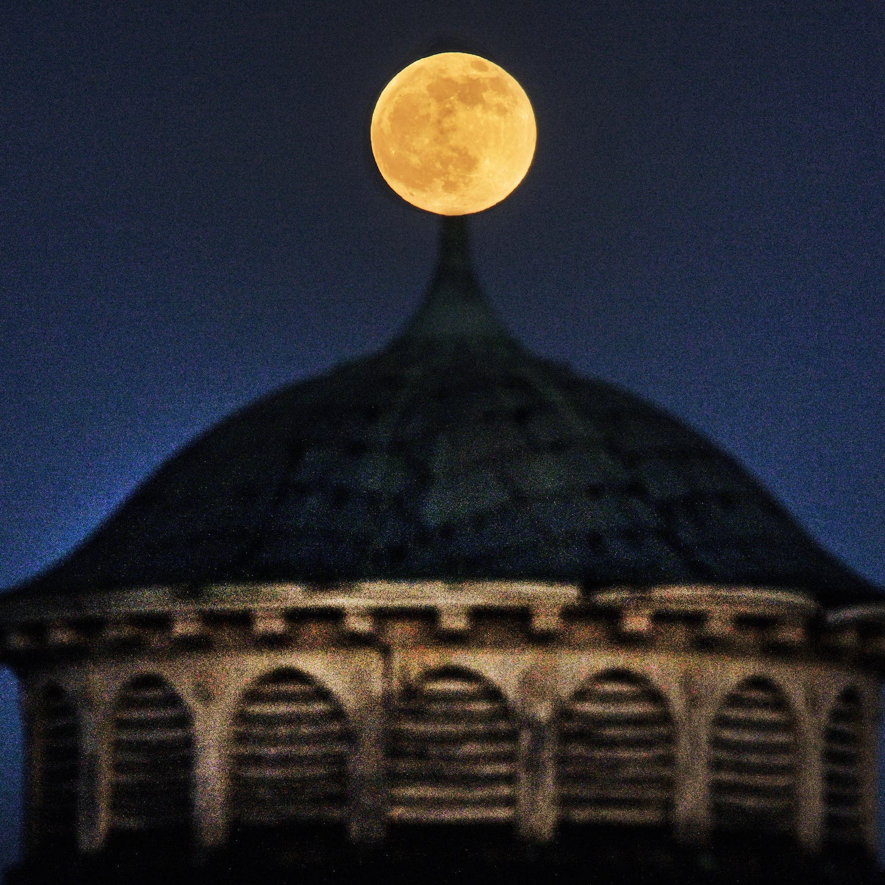 The full moon rises above Hooper Turret, a round stone building, on the property of the former Worcester State Hospital on Tuesday, December 29, 2020.