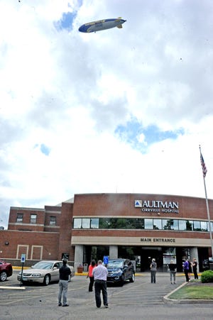 Many of Aultman Orrville Hospital employees tood in the parking lot to see the Goodyear bllimp cirlce overhead in honoring first line responders in the fight against covid 19. 