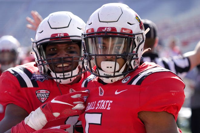Ball State safety Bryce Cosby (5) poses with Jaylin Thomas (6) after intercepting the ball against San Jose State in the first half of the Arizona Bowl NCAA college football game, Thursday, Dec. 31, 2020, in Tucson, Ariz. (AP Photo/Rick Scuteri)