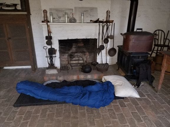 A sleeping bag is shown inside of the one of the slave quarters visited by members of Slave Dwelling Project.