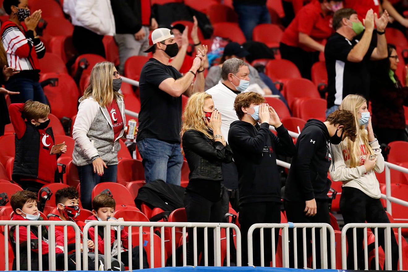 The Fickell family cheers on a third down in the second quarter of the Chick-fil-a Peach Bowl at Mercedes-Benz Stadium in Atlanta on Friday, Jan. 1, 2021. The Bearcats led 14-10 at halftime. 
