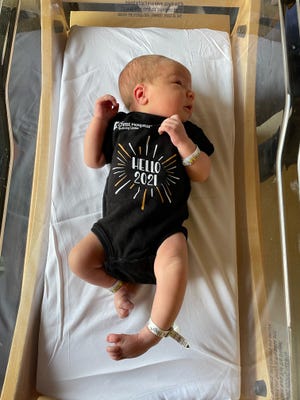 Olivia Marie Javosky, daughter of Addie Knox and Andrew Javosky models a limited edition onesie being given to newborns at The Christ Hospital Thursday and Friday.