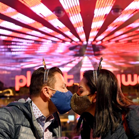 A couple kiss as they celebrate New Year's Eve alo