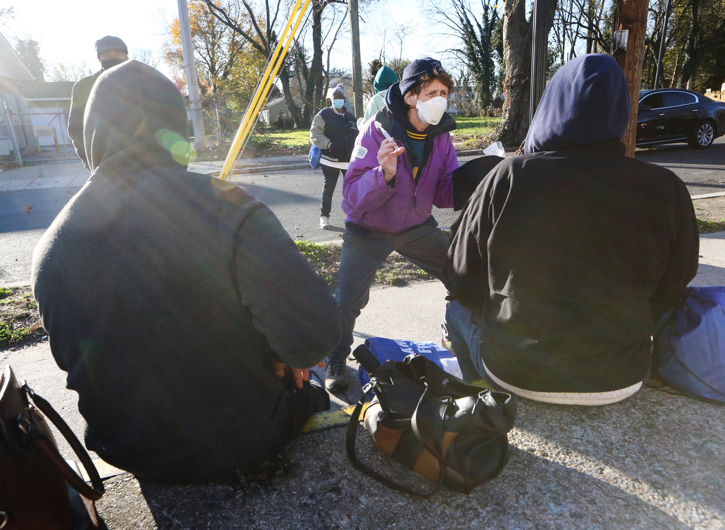 Dr. Sandra Gibney gives instructions for Naloxone as she helps distribute the anti-overdose treatment to people congregating on S. New Street just off the Dover downtown business district.