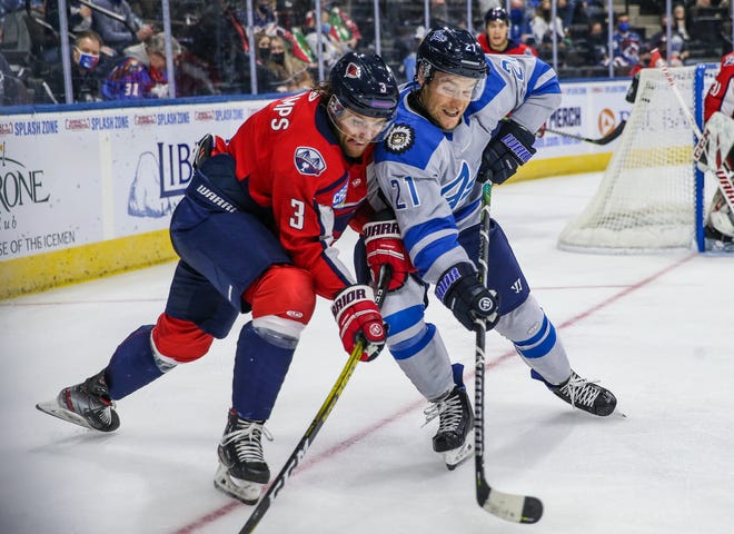 South Carolina Stingrays defenseman Macoy Erkamps (3) and Jacksonville Icemen right wing Jared VanWormer (21) vie for the puck during the first period of an ECHL hockey game at Veterans Memorial Arena in Jacksonville, Fla., Saturday, Jan. 2, 2021.  [Gary Lloyd McCullough/For the Jacksonville Icemen]