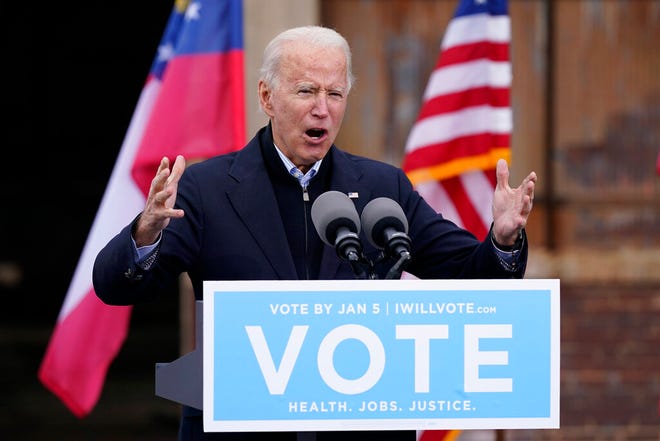 FILE - In this Tuesday, Dec. 15, 2020, file photo, President-elect Joe Biden speaks at a drive-in rally for Georgia Democratic candidates for U.S. Senate Raphael Warnock and Jon Ossoff, in Atlanta. The first full week of 2021 is shaping up to be one of the biggest of Bidenâ€™s presidency. And he hasnâ€™t even taken office yet. (AP Photo/Patrick Semansky, File)