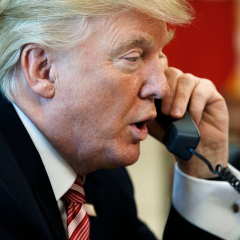President Donald Trump talks on the telephone in t