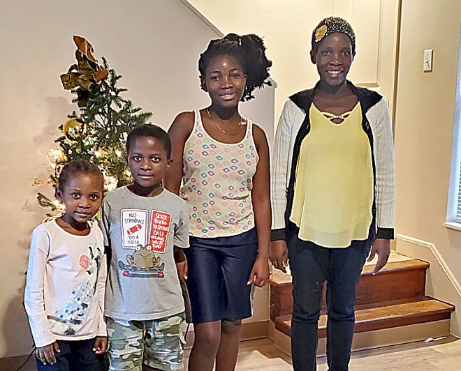 Mereceline Nyirabutabire, far right. poses with her children with donated supplies and gifts from City of Refuge. She arrived here from a refugee camp in Uganda.