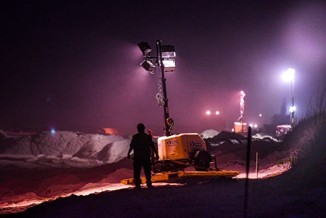 Contractors working 24 hours a day to complete a major beach renourishment project at Patrick Space Force Base. The work site under lights takes on the appearance of an outpost in a science fiction movie.