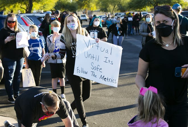 Parents and teachers protest schools reopening amid the COVID-19 pandemic at the Chandler Unified School District offices on Jan. 4, 2021.