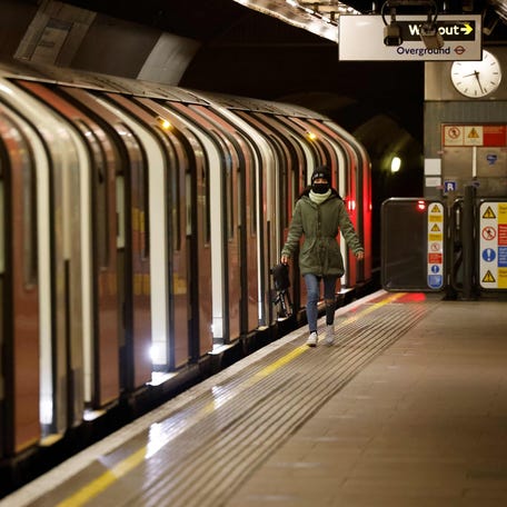 Commuters travel on the London underground as Britain enters a national lockdown in London on Jan. 5, 2021. Prime Minister Boris Johnson announced a six-week lockdown for England's 56 million people, including the closure of schools, after a surge in coronavirus cases brought warnings that hospitals could soon face collapse.