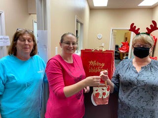 Pictured, Peg Boyle, Tiffany Overton of the HomeStead Senior Care with Jayne Bell, sister. Kim Koonce, not pictured, also assisted with the donation. [CONTRIBUTED PHOTO] 