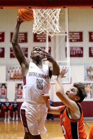 Muldrow's Trenden Collins looks for the dunk in the paint past Sallisaw's Jackson Obregon in the first quarter, Tuesday, Jan. 5, at Muldrow during the annual Sequoyah County Classic Basketball Tournament.