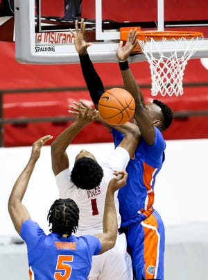 Alabama forward Herb Jones (1) is sandwiched between Florida defenders as the Crimson Tide hosted the Gators in Coleman Coliseum on Tuesday. [Staff Photo/Gary Cosby Jr.]