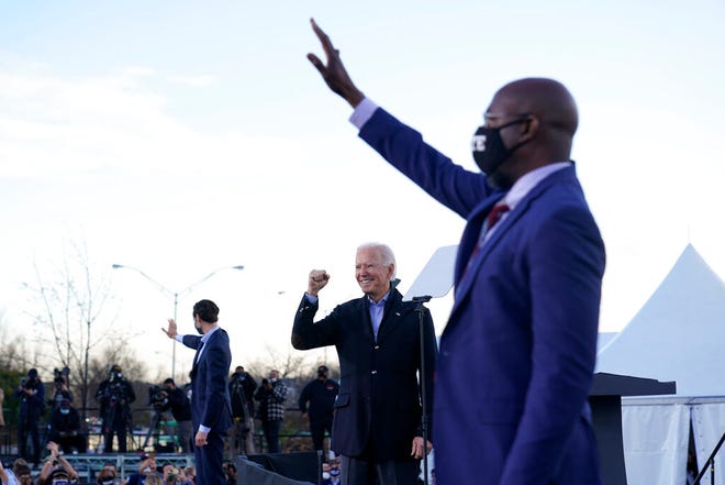 President-elect Joe Biden campaigns in Atlanta, Monday, Jan. 4, 2021, for Senate candidates Raphael Warnock, right, and Jon Ossoff, left. (AP Photo/Carolyn Kaster)