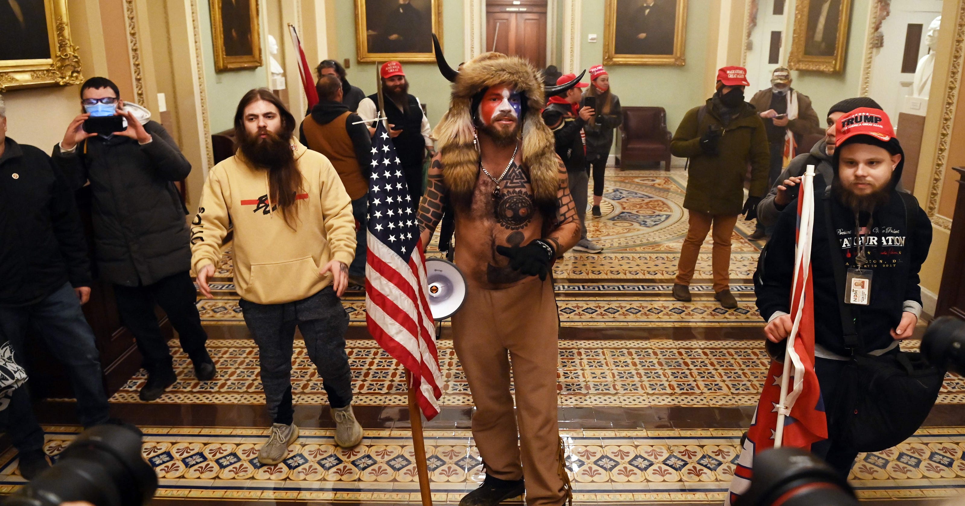 Jake Angeli who wore fur hat and horns as mob raided U S Capitol