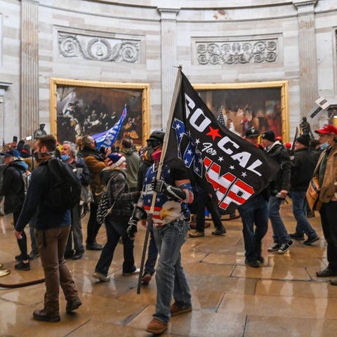 Pro-Trump rioters roam under the Capitol Rotunda a
