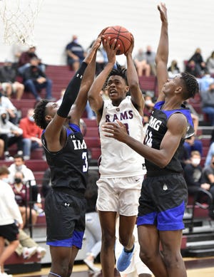 Riverview Rams' Jayven Millien (13) is fouled by the IMG Academy Ascenders players Eric Dailey Jr. (3) and Moussa DiaBate (14) during a home non-conference game at Riverview High School on Wednesday evening, Jan. 6, 2021.