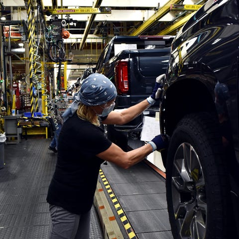 A worker wears a face mask while building GM's ful