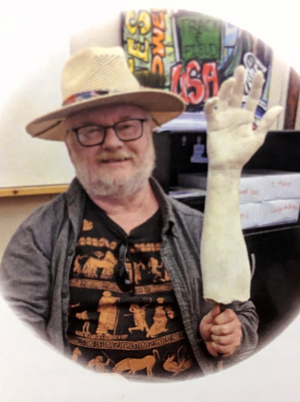 Dan Spector holds a cast of a human hand and arm. This photo was taken during one of his first visits to the Memphis Challenge office. He later taught high school students how to make plaster casts of their own hands and use them to tell a story.