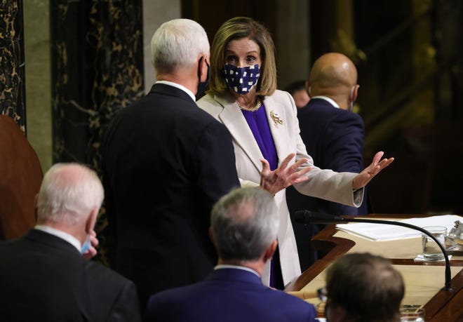 U.S. Speaker of the House Nancy Pelosi (R) (D-CA) talks with Vice President Mike Pence during the joint session of Congress on January 07, 2021 in Washington, DC. Lawmakers affirmed President-elect Joe Biden's win.