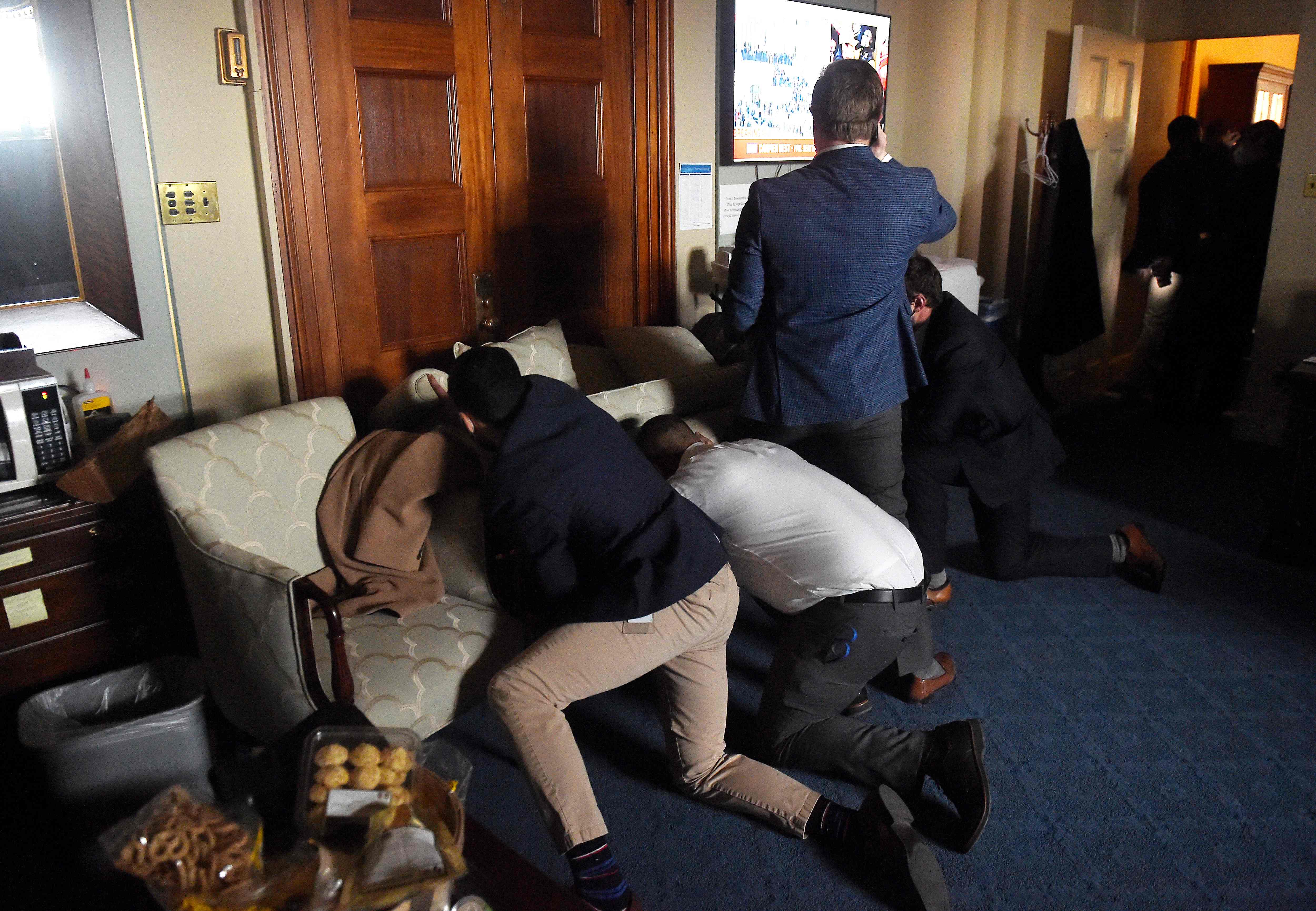 Congress staffers barricade themselves after Trump supporters stormed inside the U.S. Capitol in Washington, D.C., on Jan. 6, 2021.