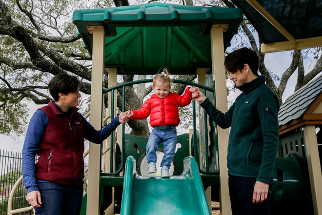 Tres and Audrey Hinds help their daughter, Josephine, down the slide outside of St. John's United Methodist Church in Austin. The church is allowing same-sex weddings in the sanctuary as well as support any qualified candidate for ministry regardless of sexual orientation.