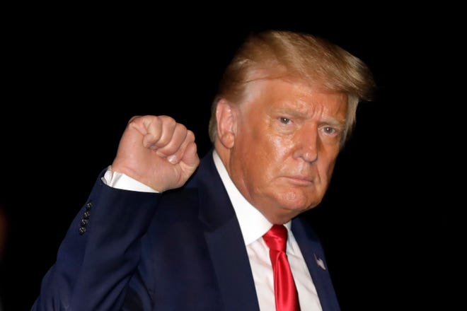 President Donald Trump pumps his fist as he walks on the South Lawn of the White House upon his return to Washington, D.C., from Tampa, Florida, on July 31. (Yuri Gripas/Abaca Press/TNS)