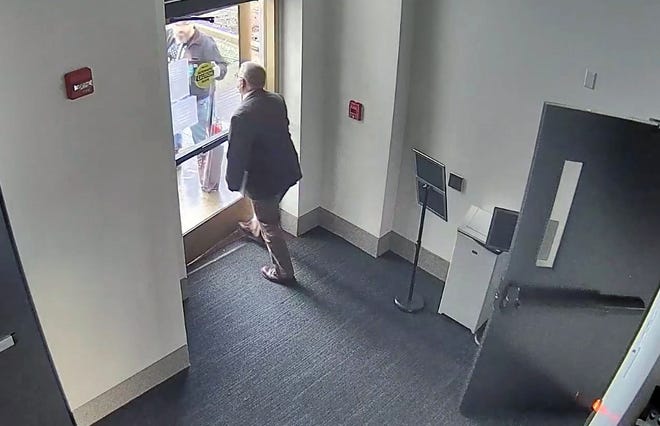 A still from a security camera showing Rep. Mike Nearman of Independence opening an exterior door, which allowed rioters access to the Oregon State Capitol building on Dec. 21, 2020.