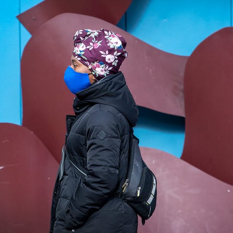 A woman wearing a face mask to protect against the