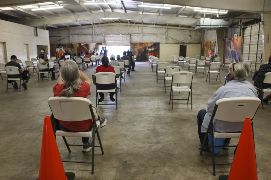 After being vaccinated, people wait 15 minutes as recommended by the CDC to check for adverse reactions in the observation area Tuesday, Jan. 5, 2021, at the COVID-19 vaccination clinic on the Rio Grande Valley Livestock Show grounds in Mercedes, Texas.