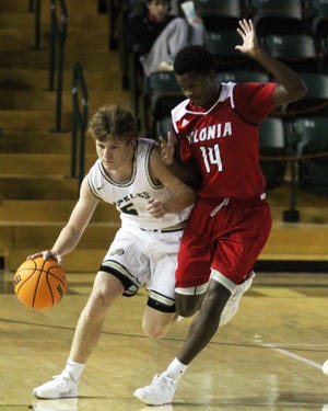 Alma guard Jacob Coursey drives up the court as Vilonia guard Jakell Lovelace defends in the first period of Friday's game against Vilonia at the Charles B. Dyer Arena in Alma, Friday, Jan. 8, 2021.