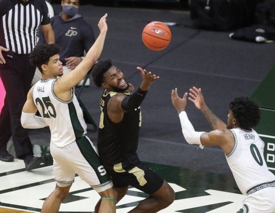 Michigan State Spartans forwards Malik Hall (25) and   Aaron Henry defend Purdue Boilermakers forward Trevion Williams during the second half at Breslin Center in East Lansing, Friday, Jan. 8, 2021.