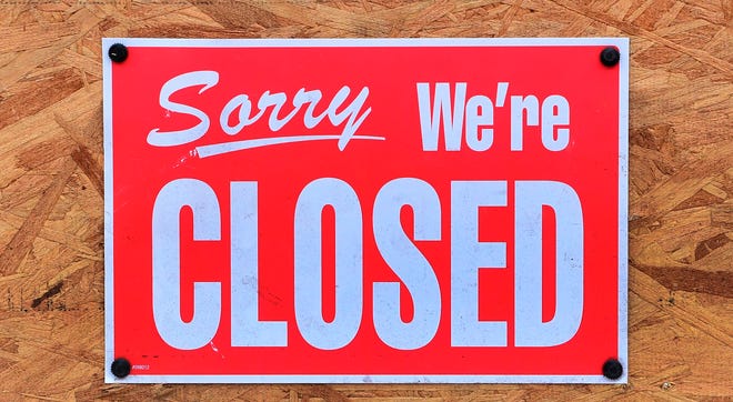 A "Closed" sign is seen amid the ccoronavirus pandemic in Los Angeles, California on December 5, 2020.