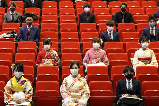Participants sit with social distancing as a preventive measure against the Covid-19 coronavirus during a coming-of-age ceremony in Namie, Fukushima Prefecture on January 9, 2021.