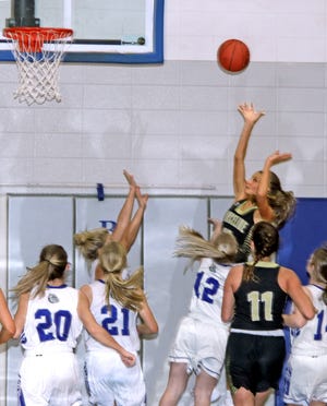 Junior Ramzee Bruner of the Marceline High School basketball Lady Tigers hits a tough angle shot over multiple Brookfield defenders to give MHS a 5-2 lead in the first quarter of Friday's (Jan. 8, 2021) non-conference game at BHS. The 5'11" Lady Tiger rang up a game-high 22 points, including converting 12 of 17 free throws, to lead MHS to a 47-29 triumph.