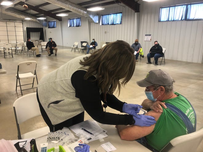 Megan Henry, RN, of the Osage County Health Department, on Jan. 5 gives a COVID-19 vaccination to Jerry Harris, chief of the Osage Hills Fire Department. The health department vaccinated 201 persons that day in Pawhuska.