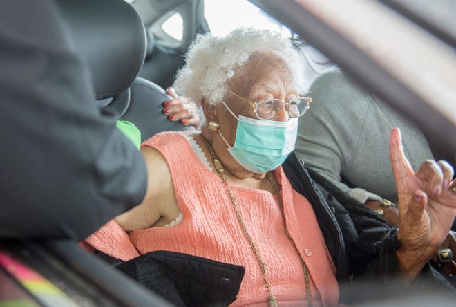 105-year-old Ruth Crawford gets her COVID-19 vaccination during the mass inoculation event at Craig-Houghton Elementary School in Augusta, Ga., Monday afternoon January 11, 2021. 