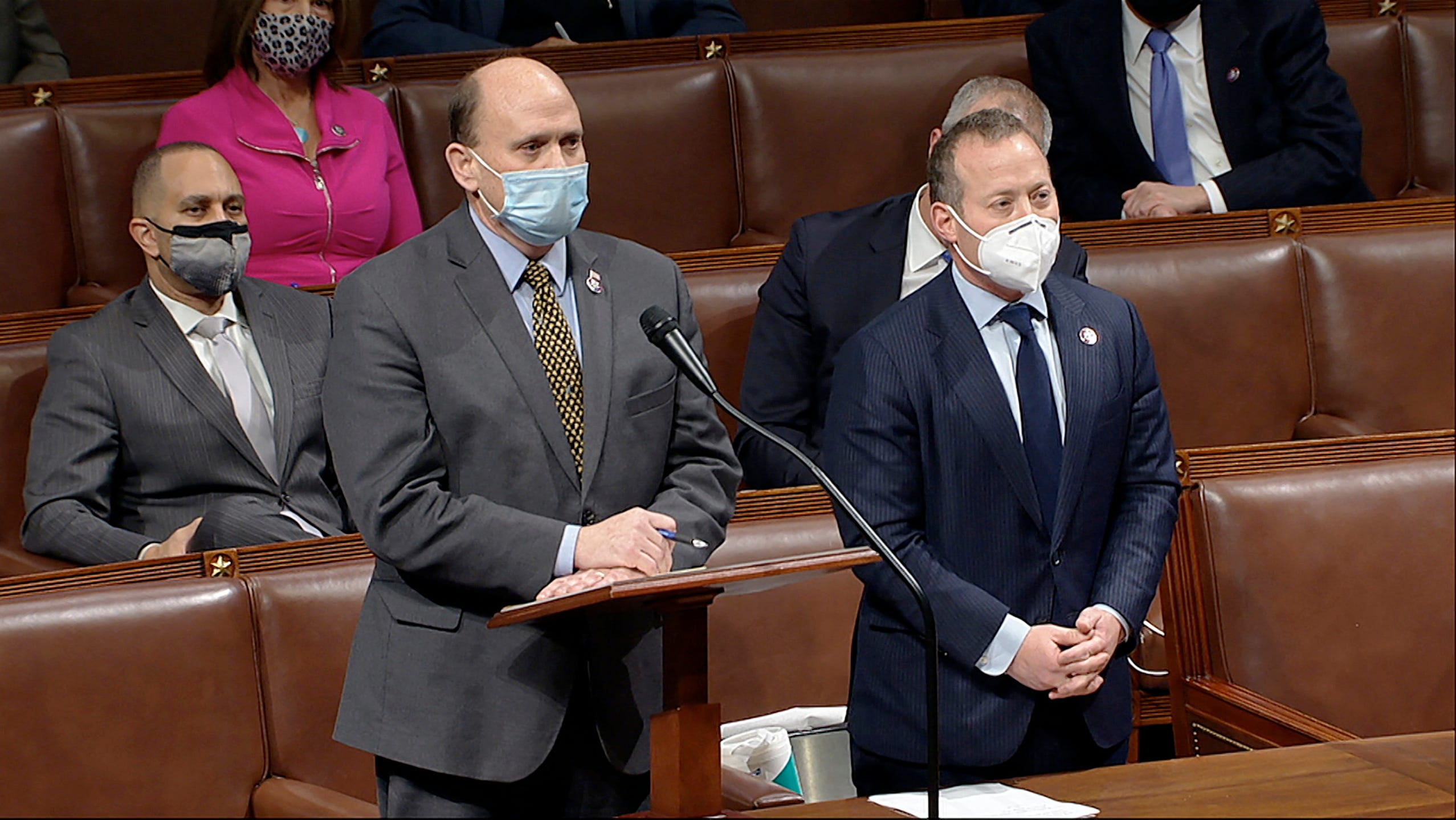 In this image from video, Rep. Josh Gottheimer, D-N.J., right, listens as Rep. Tom Reed, R-N.Y., speaks as the House reconvenes to debate the objection to confirm the Electoral College vote from Arizona, after protesters stormed into the U.S. Capitol on Wednesday, Jan. 6, 2021. (House Television via AP)