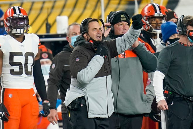 Browns acting head coach Mike Priefer, center, gives signals during the first half of an AFC wild-card playoff game against the Steelers, Sunday, Jan. 10, 2021, in Pittsburgh. (AP Photo/Keith Srakocic)
