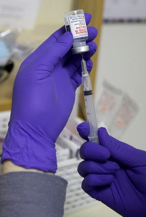 Massillon Health Department Public Health Nurse Christine Gogerty draws up a dose of the Moderna COVID-19 vaccine. The city health department will begin to administer the immunization to residents 80 and older on Jan. 19.