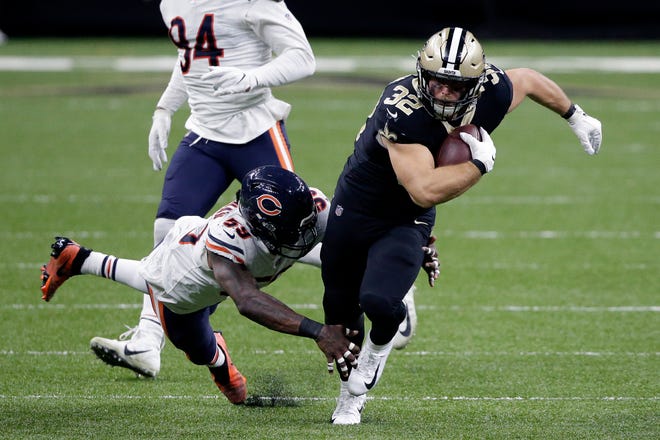 New Orleans Saints running back Michael Burton (32) carries against Chicago Bears inside linebacker Danny Trevathan (59) in the second half of an NFL wild-card playoff football game in New Orleans, Sunday, Jan. 10, 2021. (AP Photo/Butch Dill)