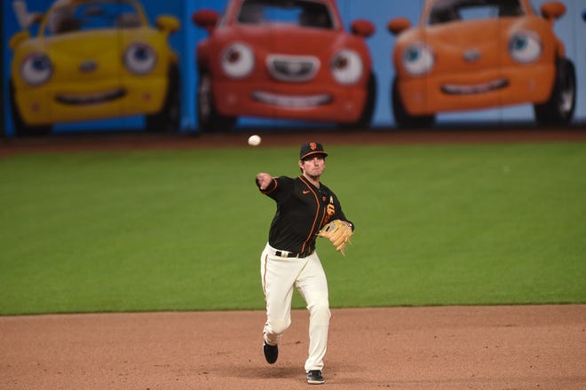 Sep 5, 2020; San Francisco, California, USA; San Francisco Giants shortstop Daniel Robertson (2) throws across to first base to record an out against the Arizona Diamondbacks in the fourth inning at Oracle Park. Mandatory Credit: Cody Glenn-USA TODAY Sports