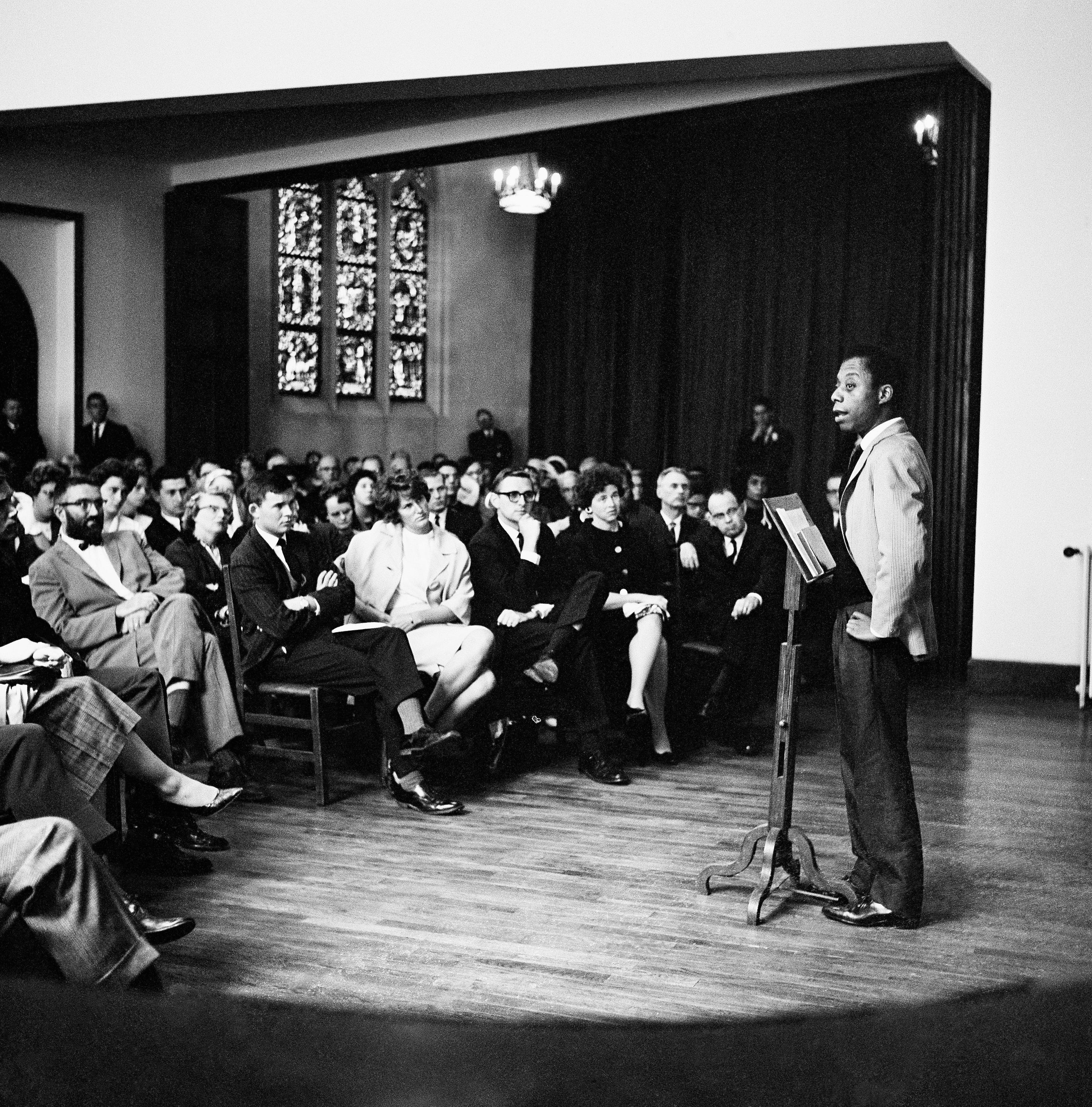A group of African American jazz musicians and others listen to author and activist James Baldwin as he presented the group's views after a sermon at the American Protestant church in Paris, France, Aug. 28, 1963. The musicians threw their spiritual weight behind the March on Washington.