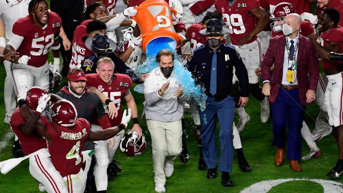 Alabama Crimson Tide head coach Nick Saban gets dunked with Gatorade after defeating the Ohio State Buckeyes in the 2021 College Football Playoff National Championship Game.