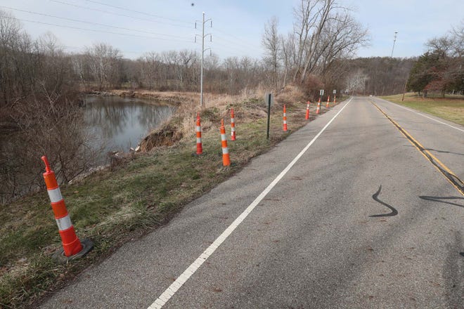 Erosion along the Cuyahoga River closed Akron-Peninsula Road because of safety concerns, seen here Wednesday, Jan. 13, 2021, in Peninsula, Ohio. The road is reopening Wednesday.